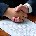 Handshake over a contract, symbolizing approval